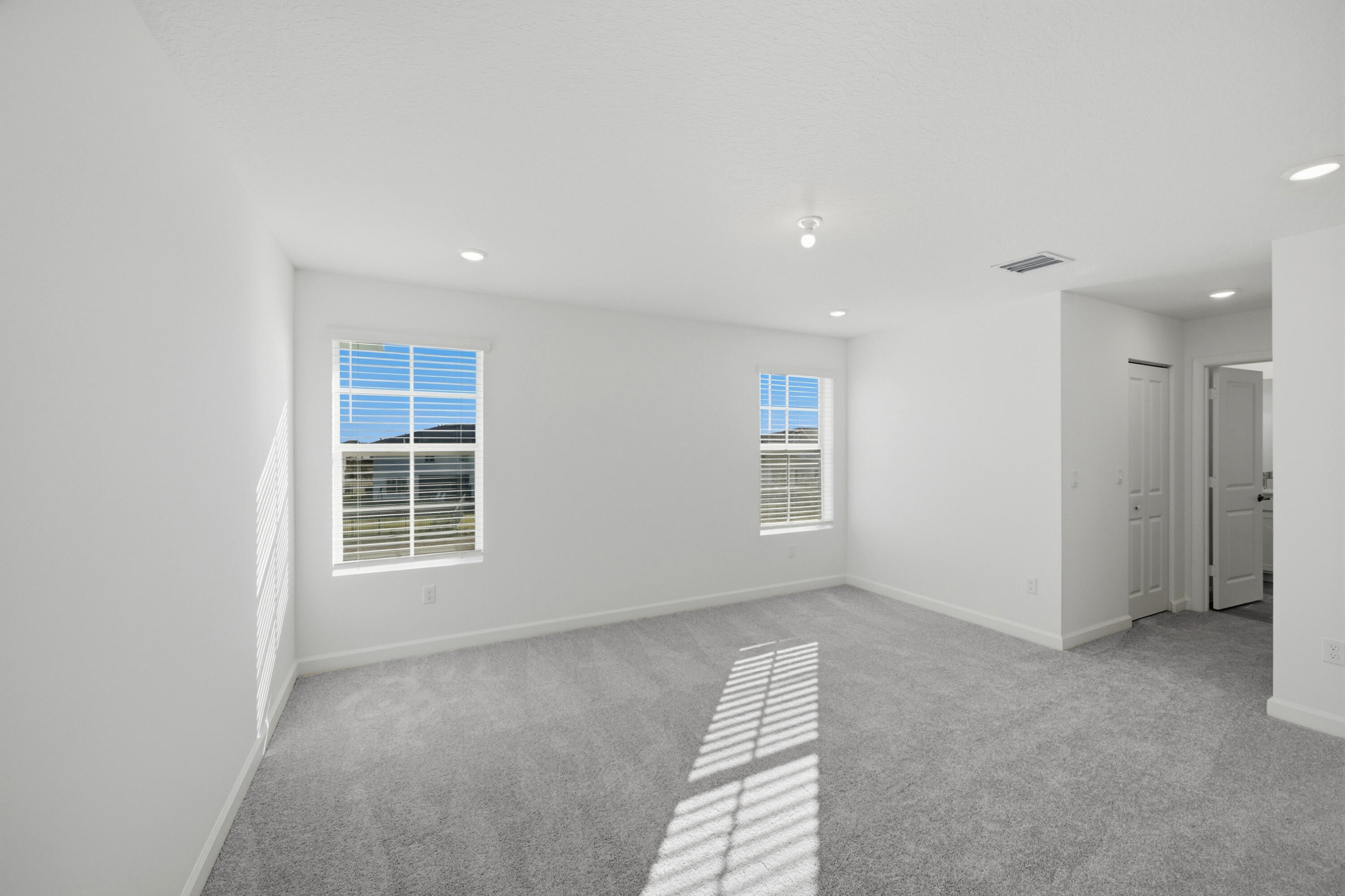 19568 Whispering Creek Road Loxahatchee, FL 33470 - Photo 17 of 30 an empty room with windows