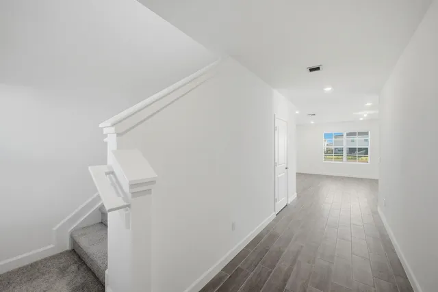 a view of hallway with wooden floor