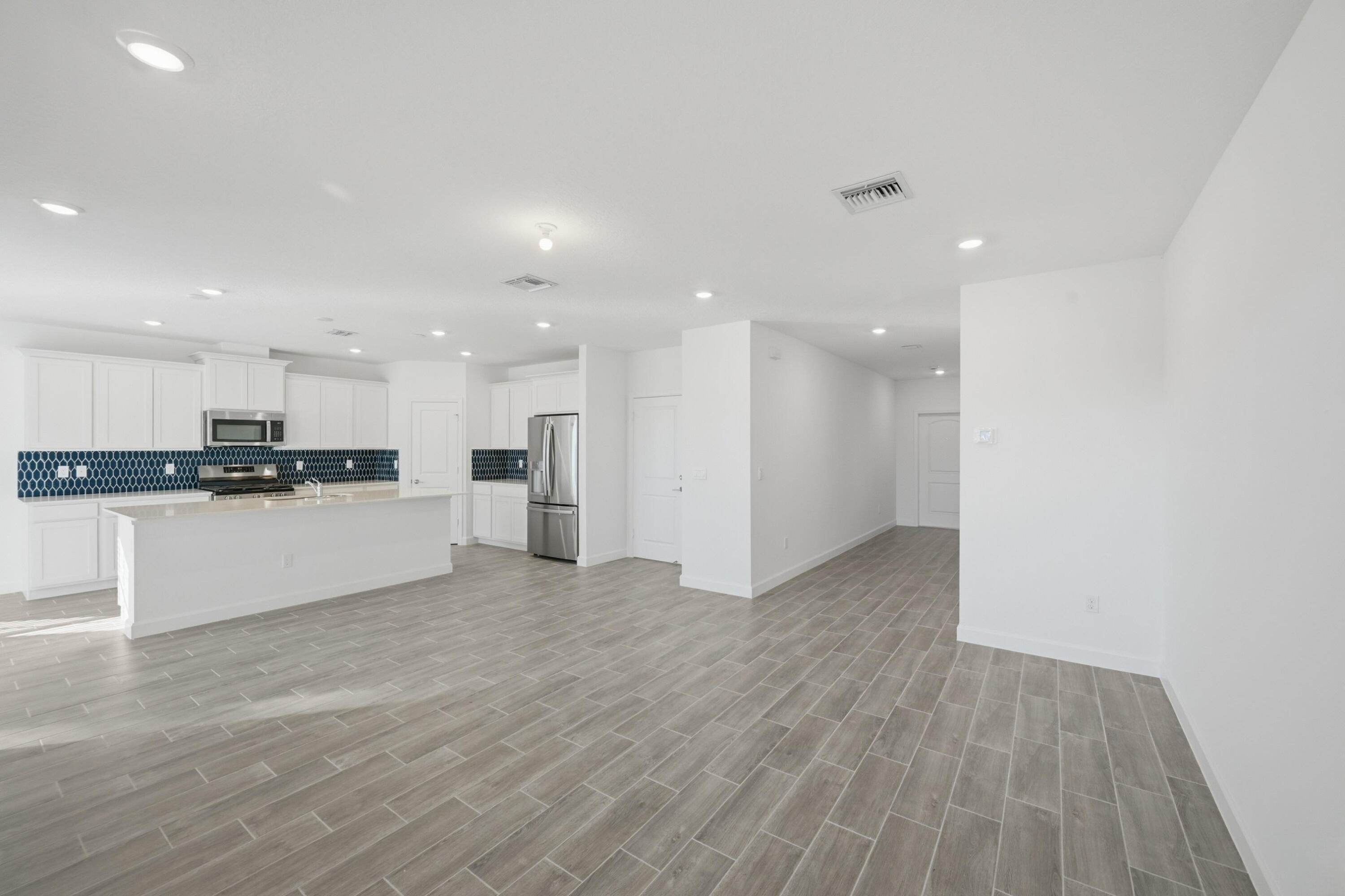 19568 Whispering Creek Road Loxahatchee, FL 33470 - Photo 5 of 30 a view of kitchen with kitchen island white cabinets and stainless steel appliances