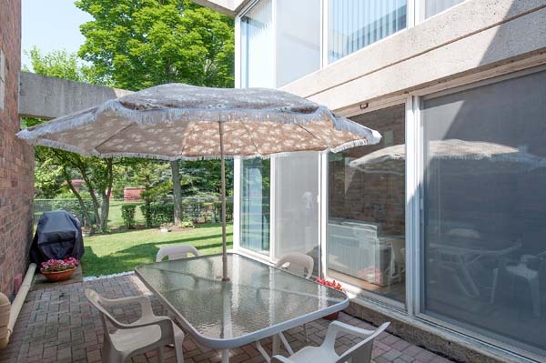 88 Avon Road, Unit 88 Northbrook, IL 60062 - Photo 9 of 17 a patio with wooden table and chairs