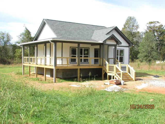 a view of a house with backyard porch and sitting area