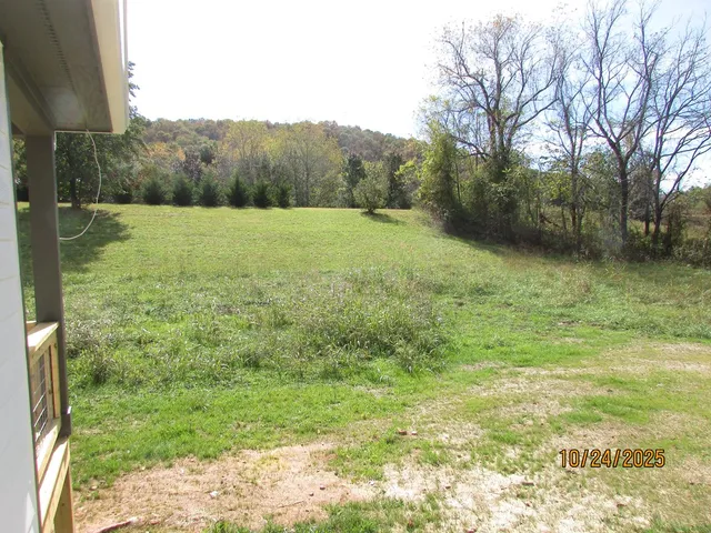 a view of a house with backyard porch and garden