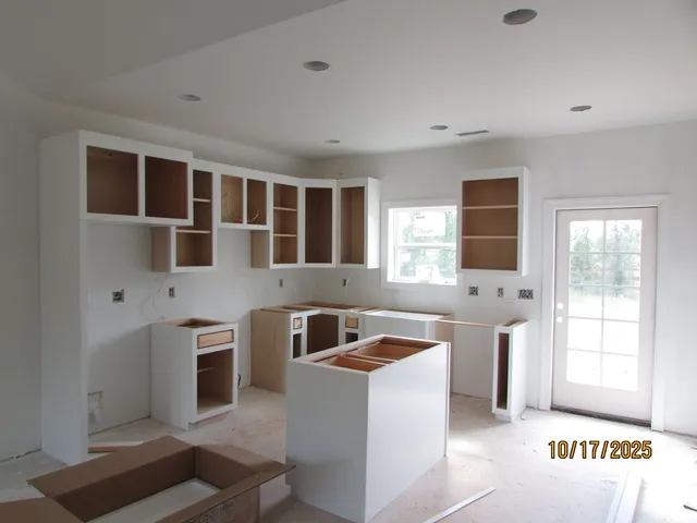 a kitchen that has a sink and a stove top oven