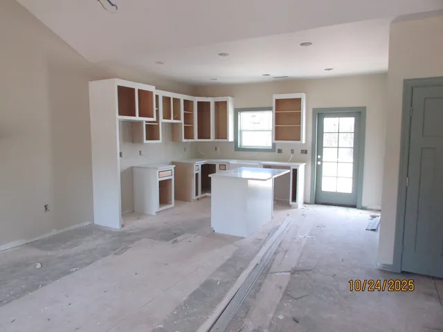 a view of a kitchen with stainless steel appliances granite countertop a stove top oven