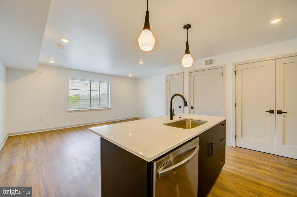 5001 Umbria Street, Unit P607 Philadelphia, PA 19128 - Photo 2 of 10 a kitchen that has a sink and a stove with wooden floor