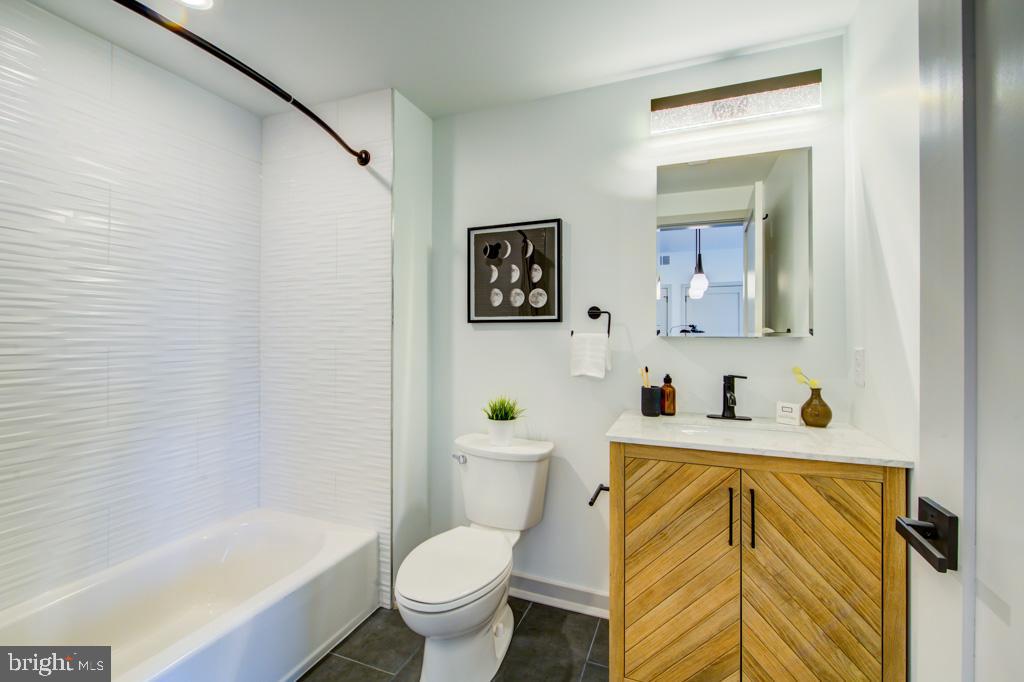5001 Umbria Street, Unit P607 Philadelphia, PA 19128 - Photo 7 of 10 a bathroom with a sink and a bathtub