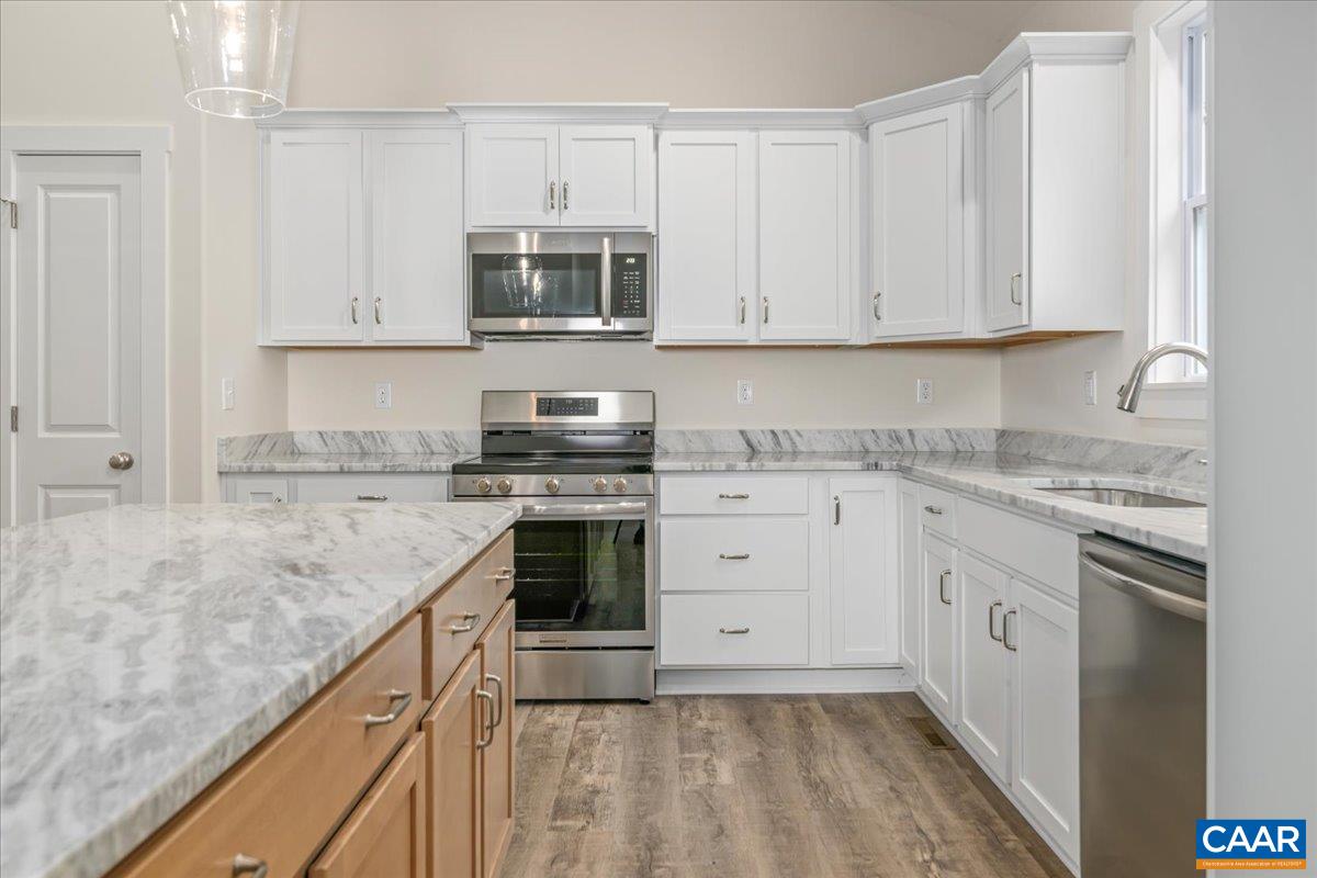 6443 Bremo Road Bremo Bluff, VA 23022 - Photo 13 of 31 a kitchen with granite countertop a sink a stove and cabinets