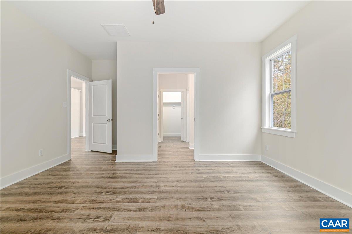 6443 Bremo Road Bremo Bluff, VA 23022 - Photo 21 of 31 an empty room with wooden floor and windows
