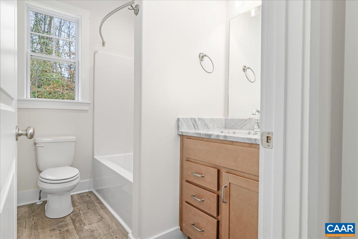 6443 Bremo Road Bremo Bluff, VA 23022 - Photo 28 of 31 a bathroom with a granite countertop sink toilet and shower