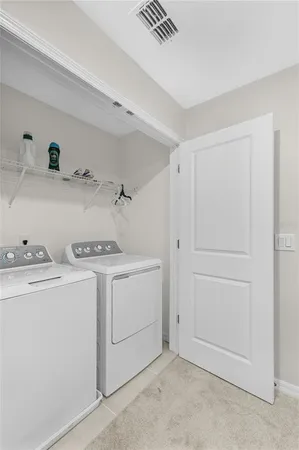a view of storage and utility room with washer and dryer