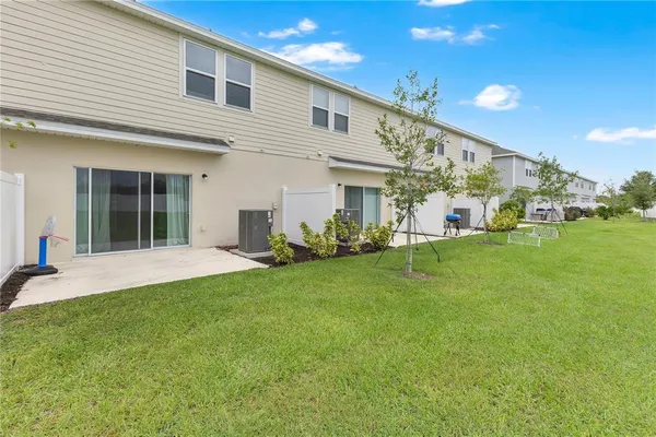 a view of an house with backyard porch and sitting area
