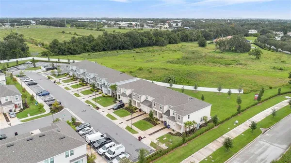 an aerial view of a house with a garden and lake view