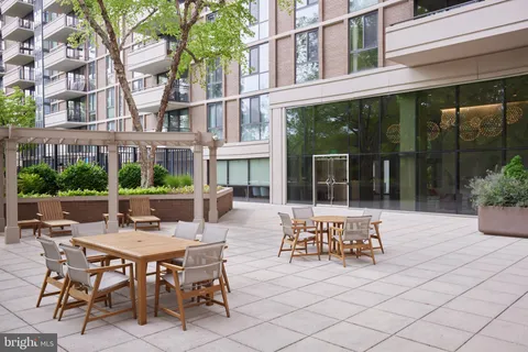 a view of a patio with table and chairs and potted plants