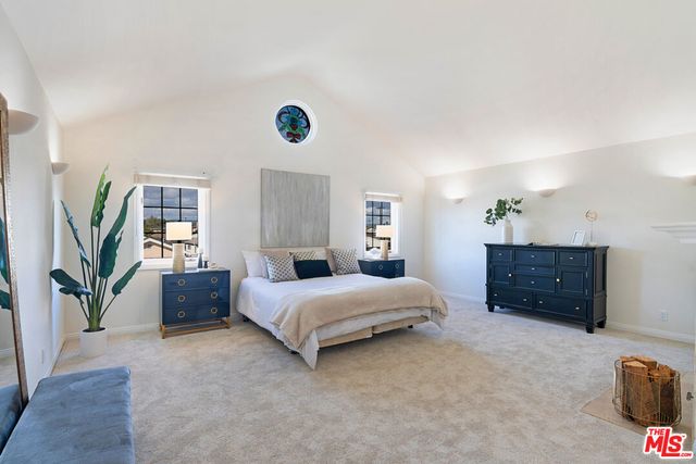 a spacious bedroom with a bed and a dresser