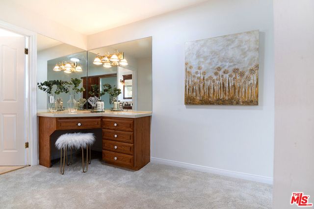 a living room with furniture and a mirror