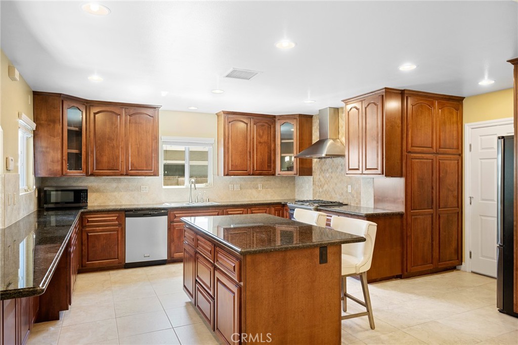 724 San Luis Rey Road Arcadia, CA 91007 - Photo 3 of 15 a kitchen with stainless steel appliances granite countertop a sink stove and refrigerator