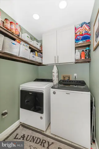 a bedroom with a bed next to a window with a flat screen tv