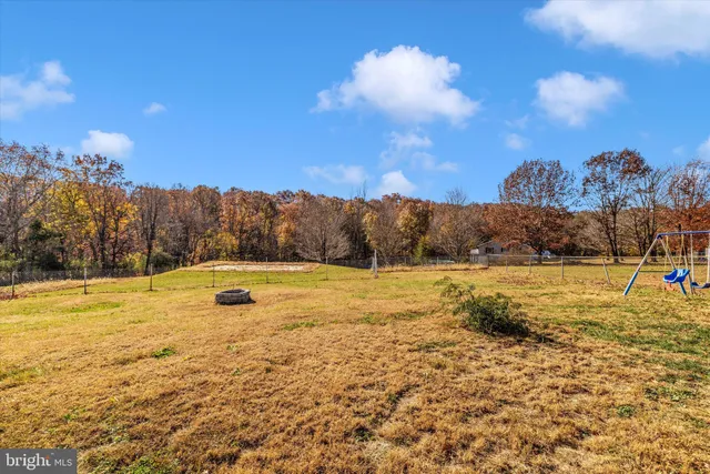 a yellow and red house with a yard