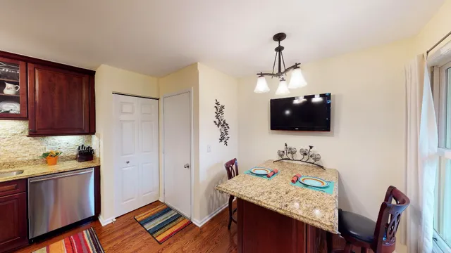 a bedroom with furniture and a flat screen tv