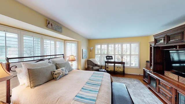 a bedroom with furniture and a flat screen tv