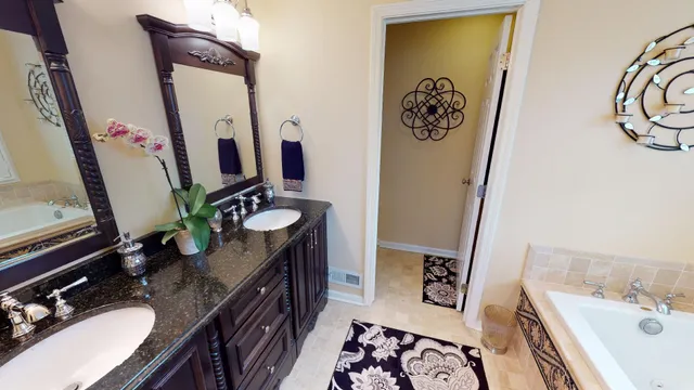 a bathroom with double vanity sink and a mirror
