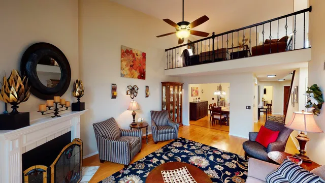 a living room with furniture a rug and a chandelier