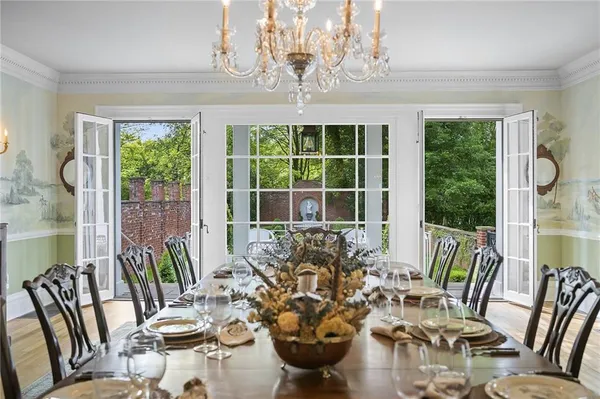 a living room with furniture flat screen tv and a large window