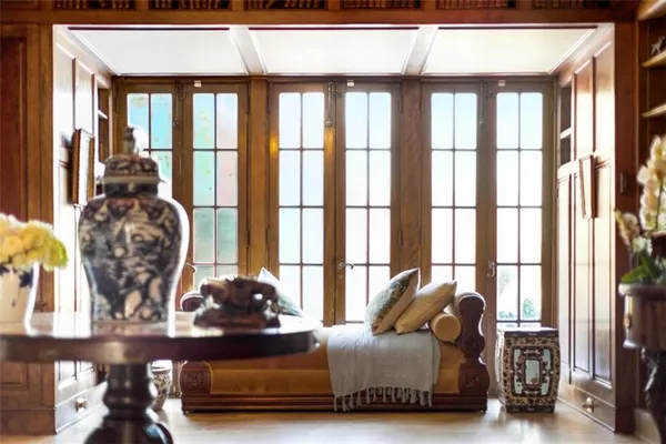 a living room with furniture a flat screen tv and large window