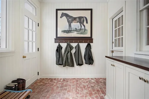 a view of entryway and hall with wooden floor