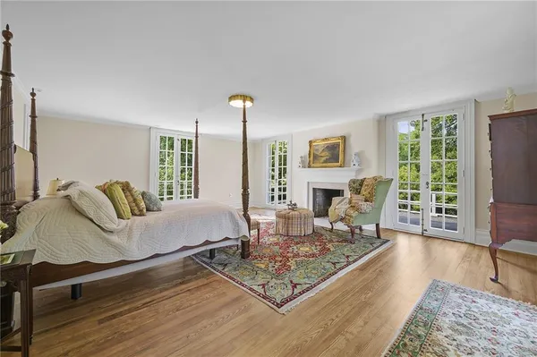 a spacious bedroom with a bed and a fireplace