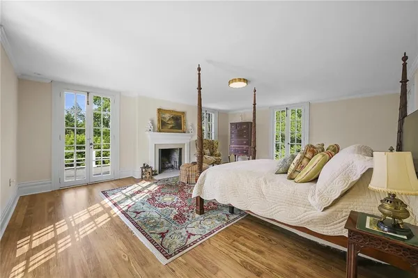 a bathroom with a granite countertop sink a mirror and a shower