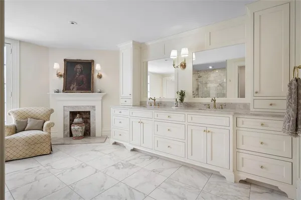 a bathroom with a granite countertop sink a mirror and a shower