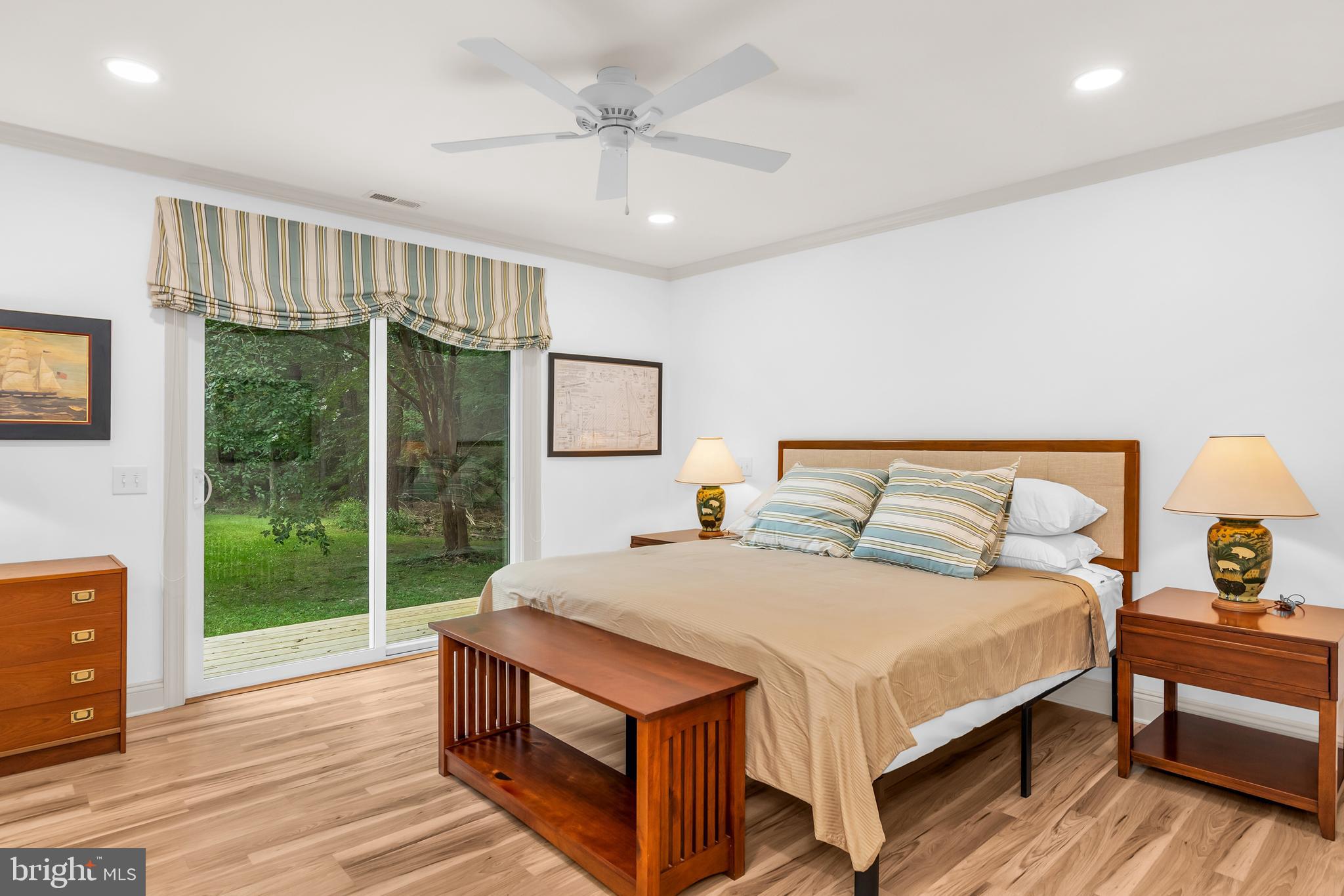 9459 New Road McDaniel, MD 21647 - Photo 23 of 27 a large bedroom with a bed and wooden floor