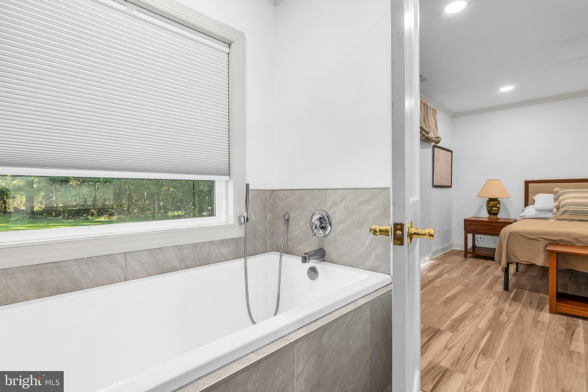 9459 New Road McDaniel, MD 21647 - Photo 24 of 27 a bathroom with a bathtub and a sink