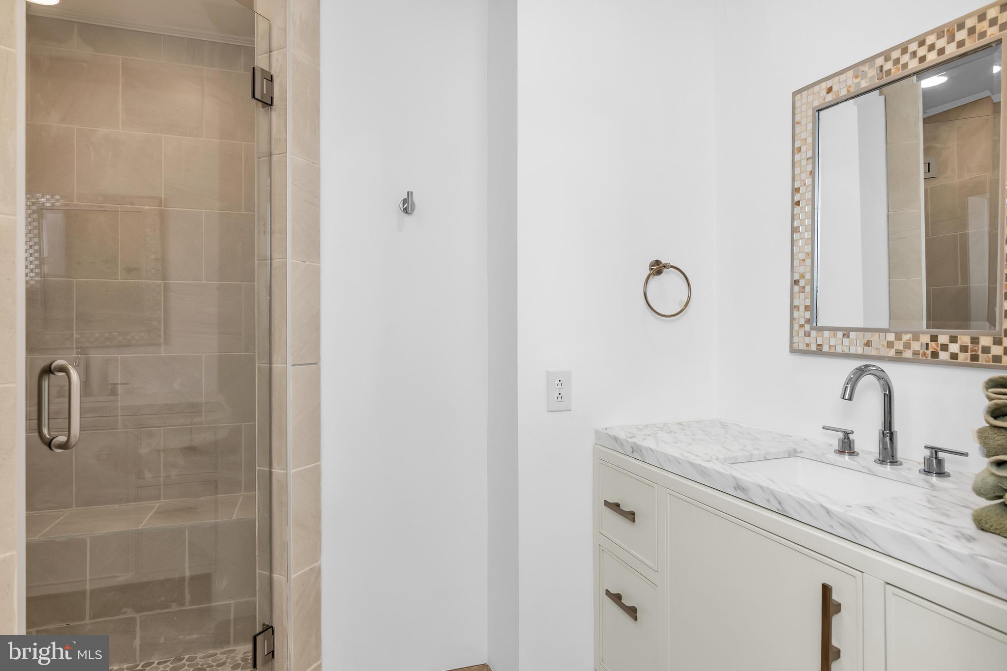 9459 New Road McDaniel, MD 21647 - Photo 26 of 27 a bathroom with a granite countertop sink a mirror and shower