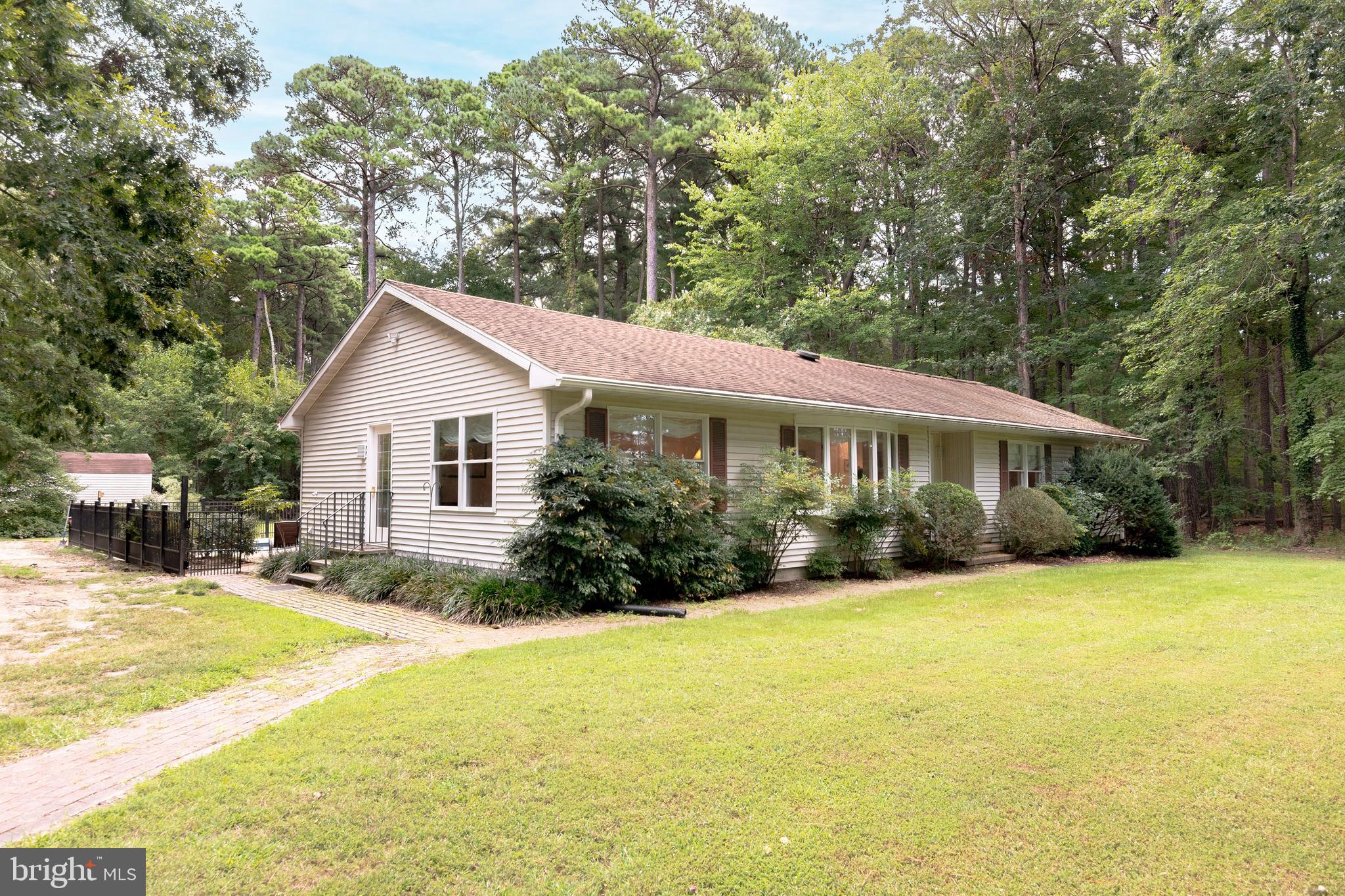 9459 New Road McDaniel, MD 21647 - Photo 3 of 27 a front view of a house with yard and green space