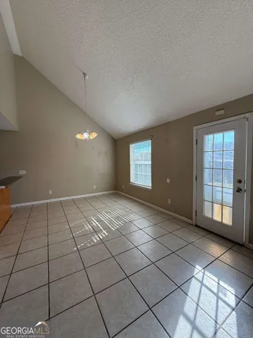 a view of an empty room and staircase