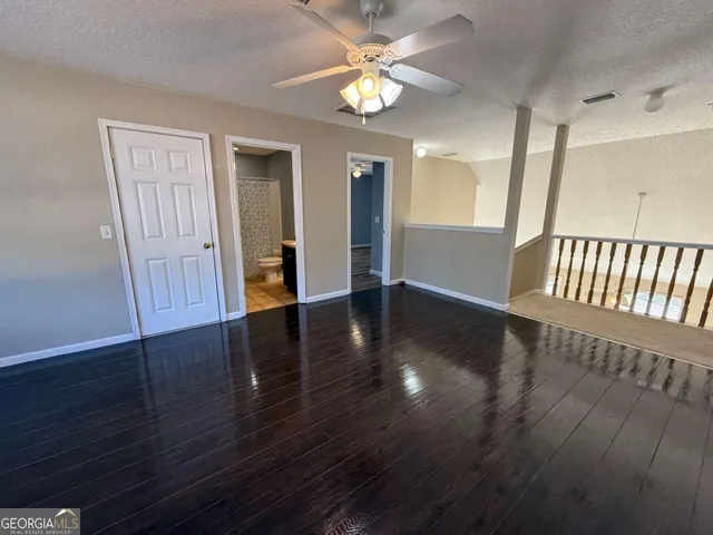 a view of backyard with barbeque grill potted plants and wooden fence