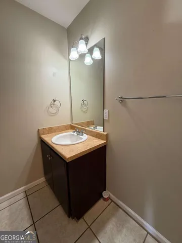 a bathroom with a sink and mirror