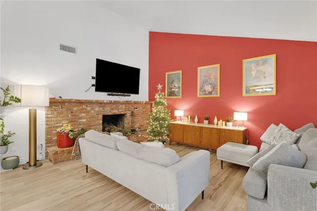 a view of a dining room with furniture a chandelier and wooden floor