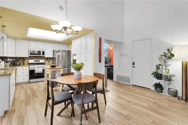 a kitchen with a sink a counter top space stainless steel appliances and cabinets