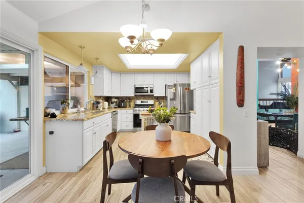 a view of a kitchen area with furniture and wooden floor