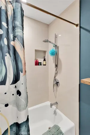 a view of a workspace with lots of stuff and hardwood floor