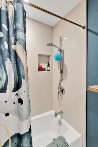 a view of a workspace with lots of stuff and hardwood floor