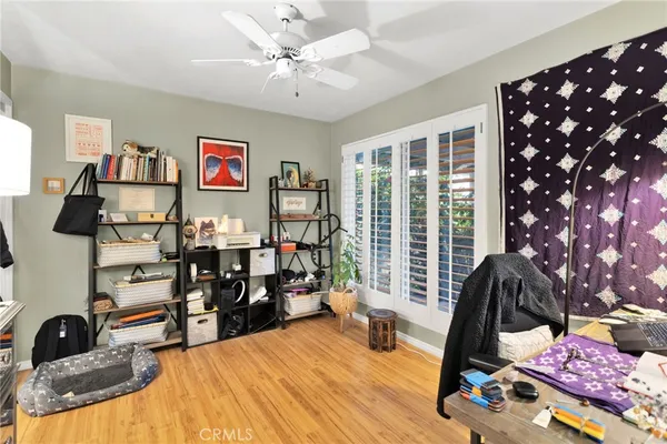 a view of a workspace with furniture and wooden floor