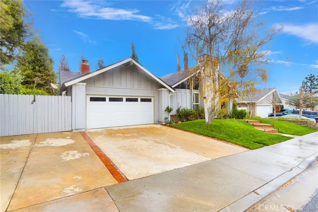 a view of a house with a yard and sitting area