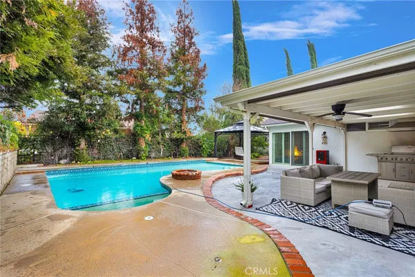 aerial view of a house with a yard and large trees
