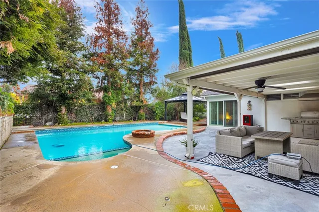 aerial view of a house with a yard and large trees
