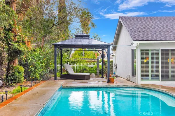 an aerial view of residential houses with outdoor space and parking