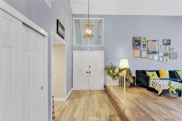 a living room with furniture wooden floor and wall painting